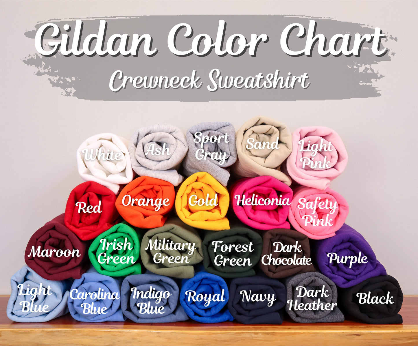 Gildan color chart for crewneck sweatshirts with various colored folded fabric samples.