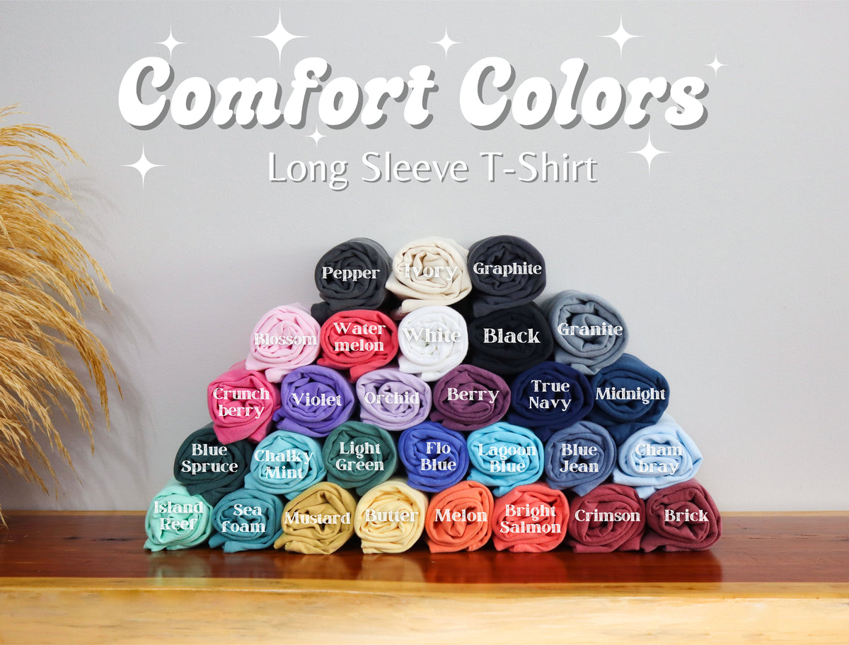 Stack of long sleeve t-shirt rolls in various colors with 'Comfort Colors' branding.