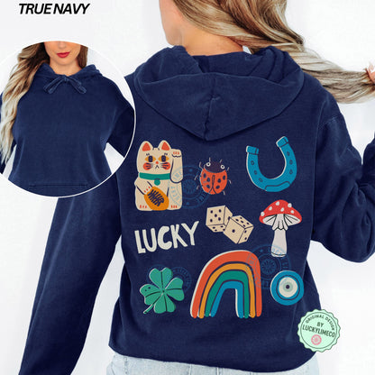 Navy hoodie with lucky symbols on the back, including a cat, ladybug, horseshoe, dice, mushroom, rainbow, and clover.