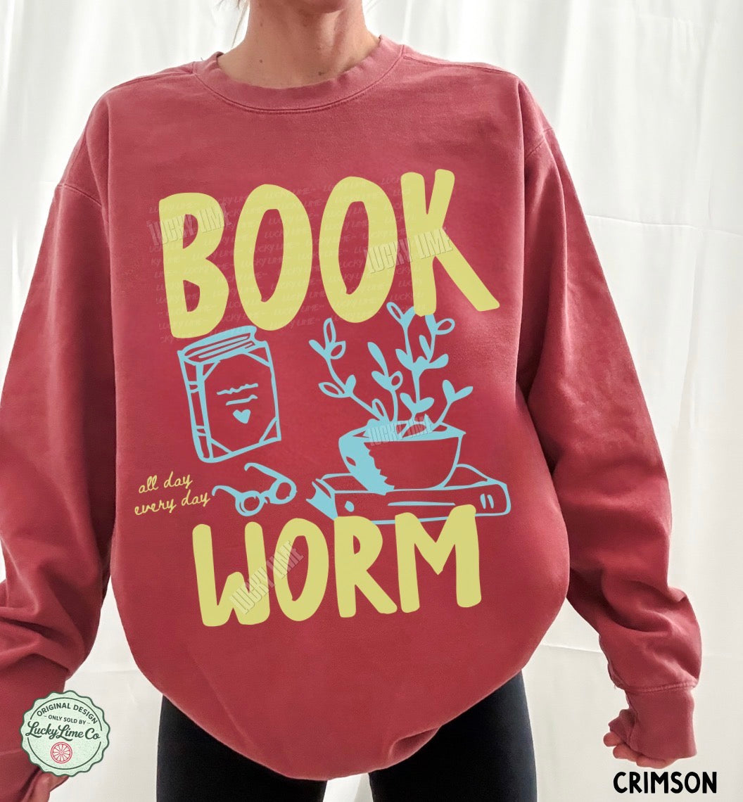 Red sweatshirt with 'BOOK WORM' text and illustrations on a white background