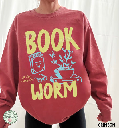 Red sweatshirt with 'BOOK WORM' text and illustrations on a white background