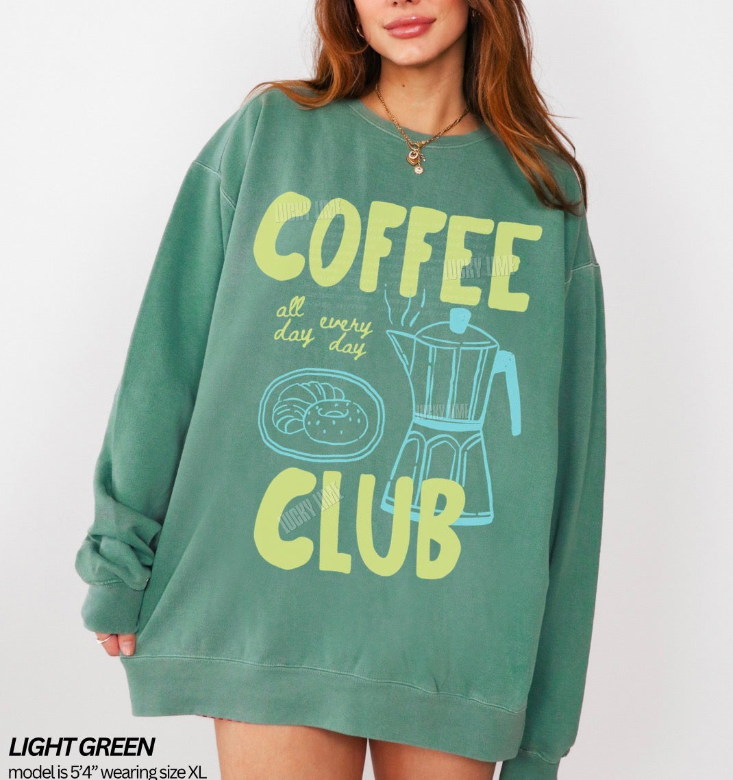 Green sweatshirt with 'Coffee Club' text and graphics worn by a model on a white background