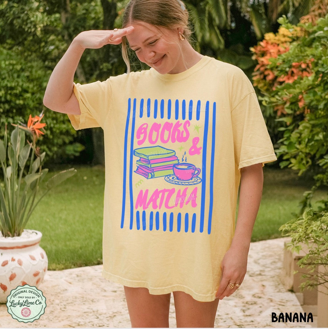 Person wearing a yellow t-shirt with 'books & matcha' design outdoors.