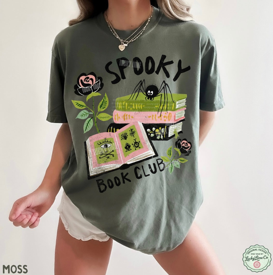 Person wearing a green t-shirt with 'Spooky Book Club' design on a plain background
