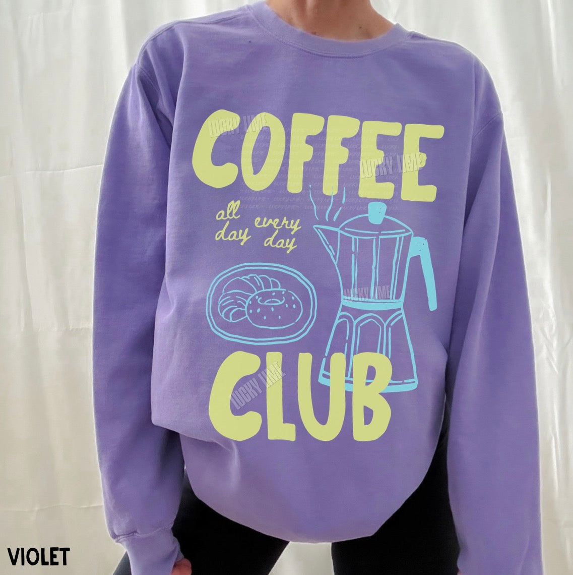 Purple sweatshirt with 'Coffee Club' design on a white background