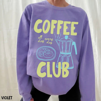 Purple sweatshirt with 'Coffee Club' design on a white background