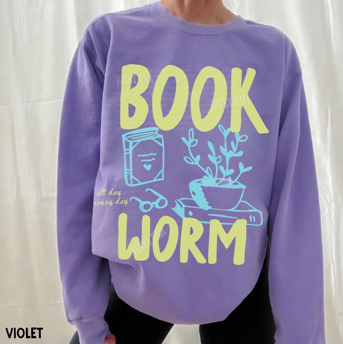 Purple sweatshirt with 'BOOK WORM' text and graphics on a white background