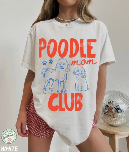 Person wearing a white t-shirt with 'Poodle Mom Club' text and dog graphics on a plain background.