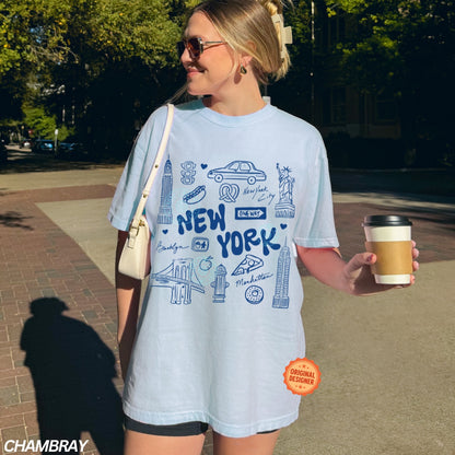 Woman wearing a light blue 'New York' t-shirt holding a coffee cup outdoors.