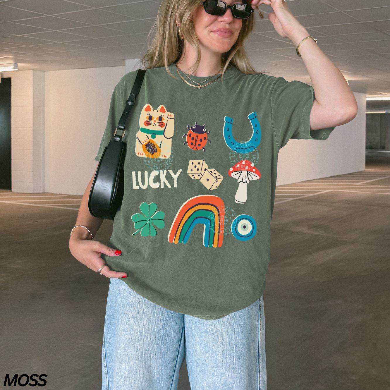 Person wearing a green t-shirt with lucky symbols and text, standing in an indoor setting.