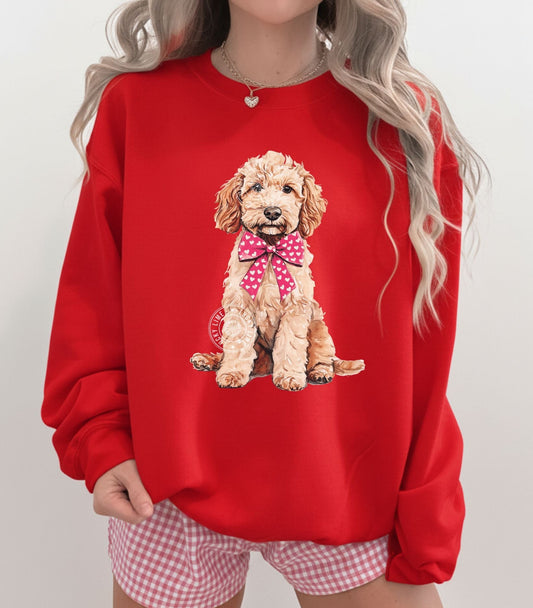 Red sweatshirt with a Goldendoodle graphic worn by a person on a plain background