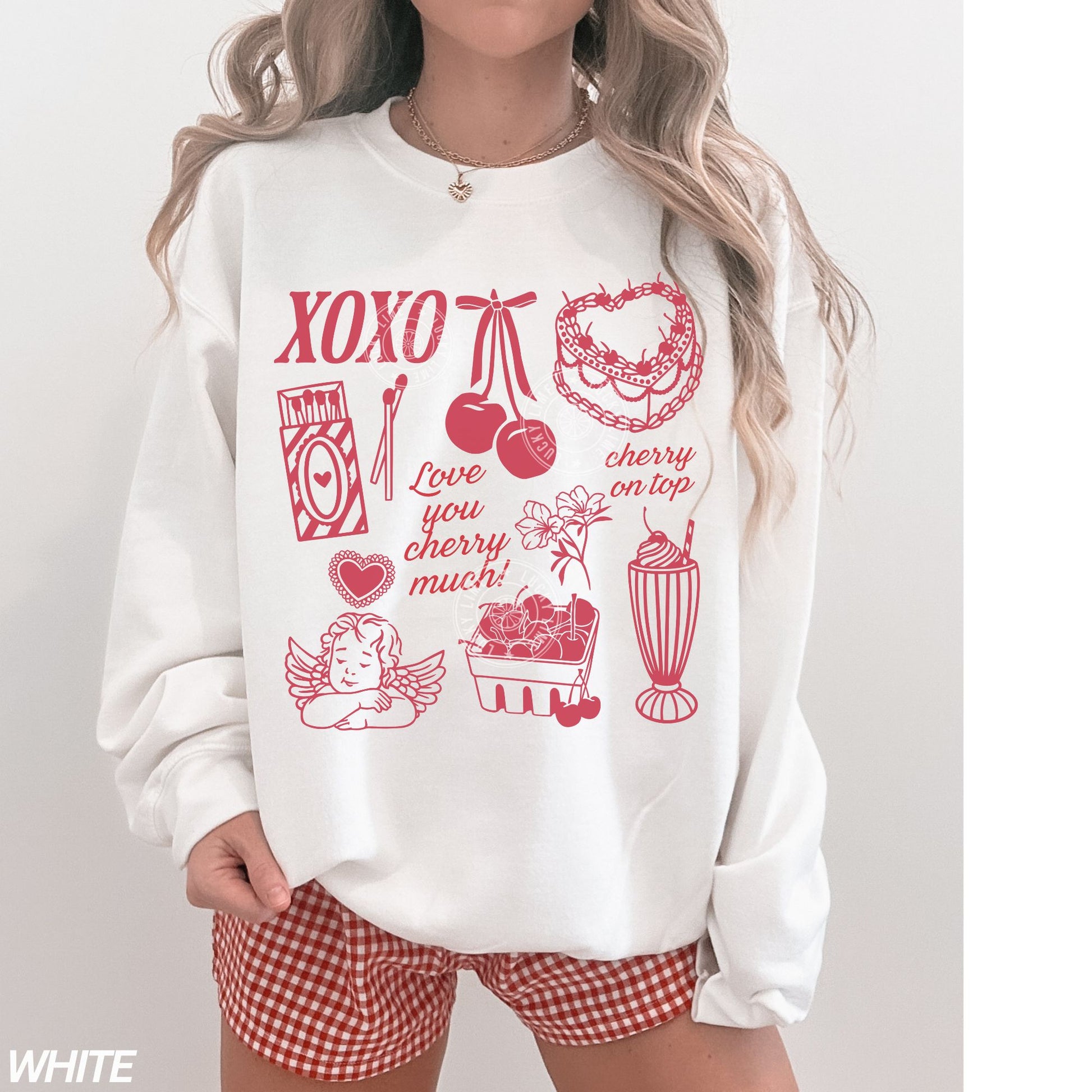 Person wearing a white sweatshirt with red Valentine graphics and text on a plain background