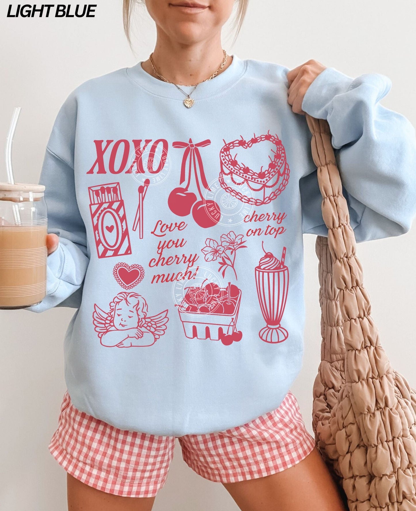 Light blue sweatshirt with vintage Valentine graphic collage on front