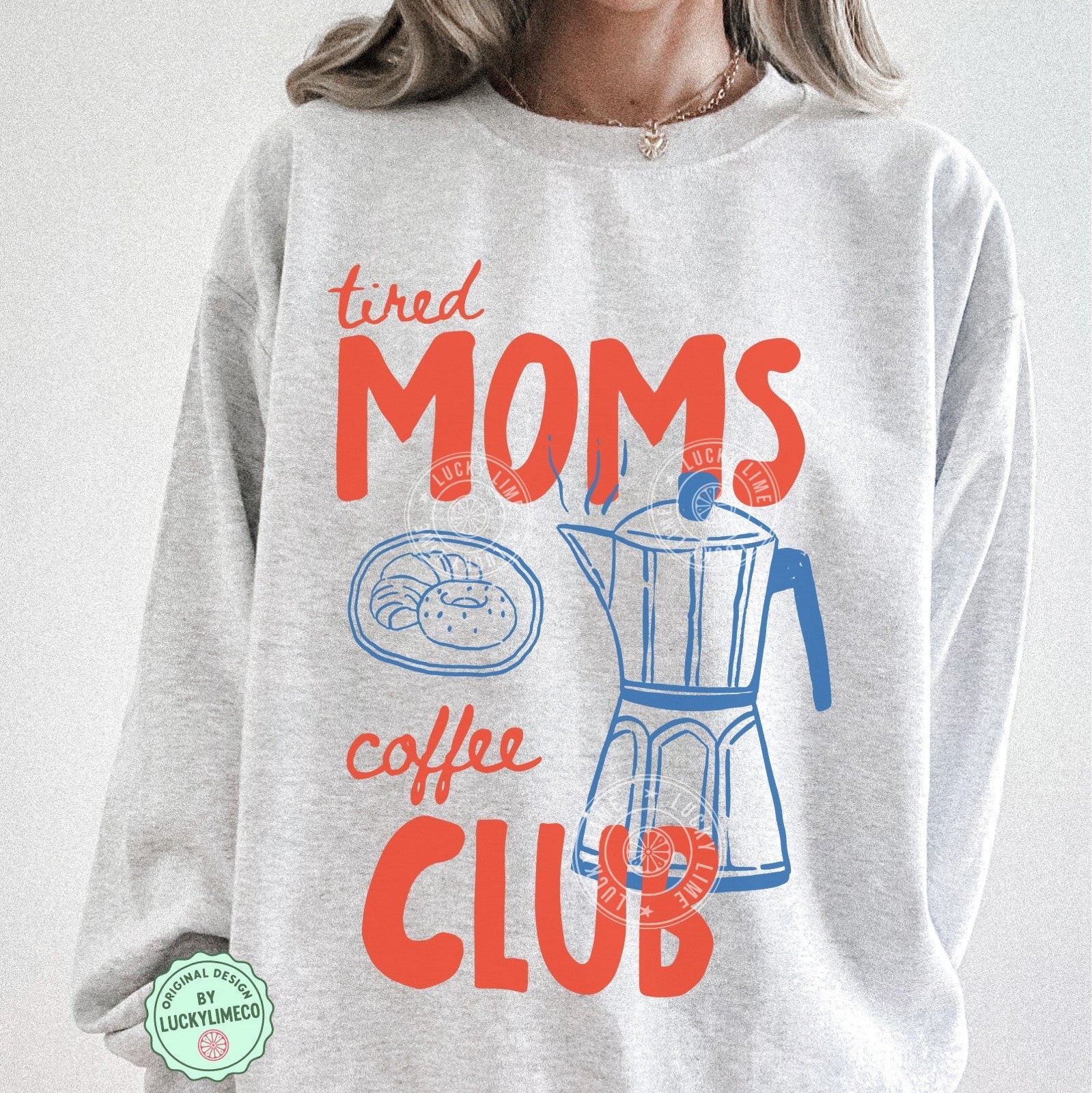 Gray sweatshirt with 'tired moms coffee club' text and graphics on a plain background