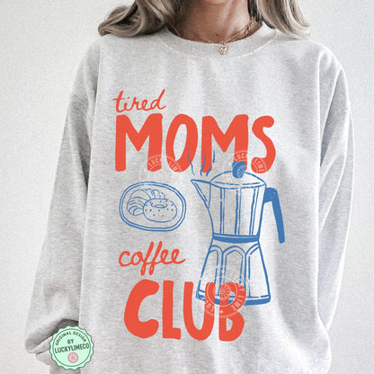Gray sweatshirt with 'tired moms coffee club' text and graphics on a plain background