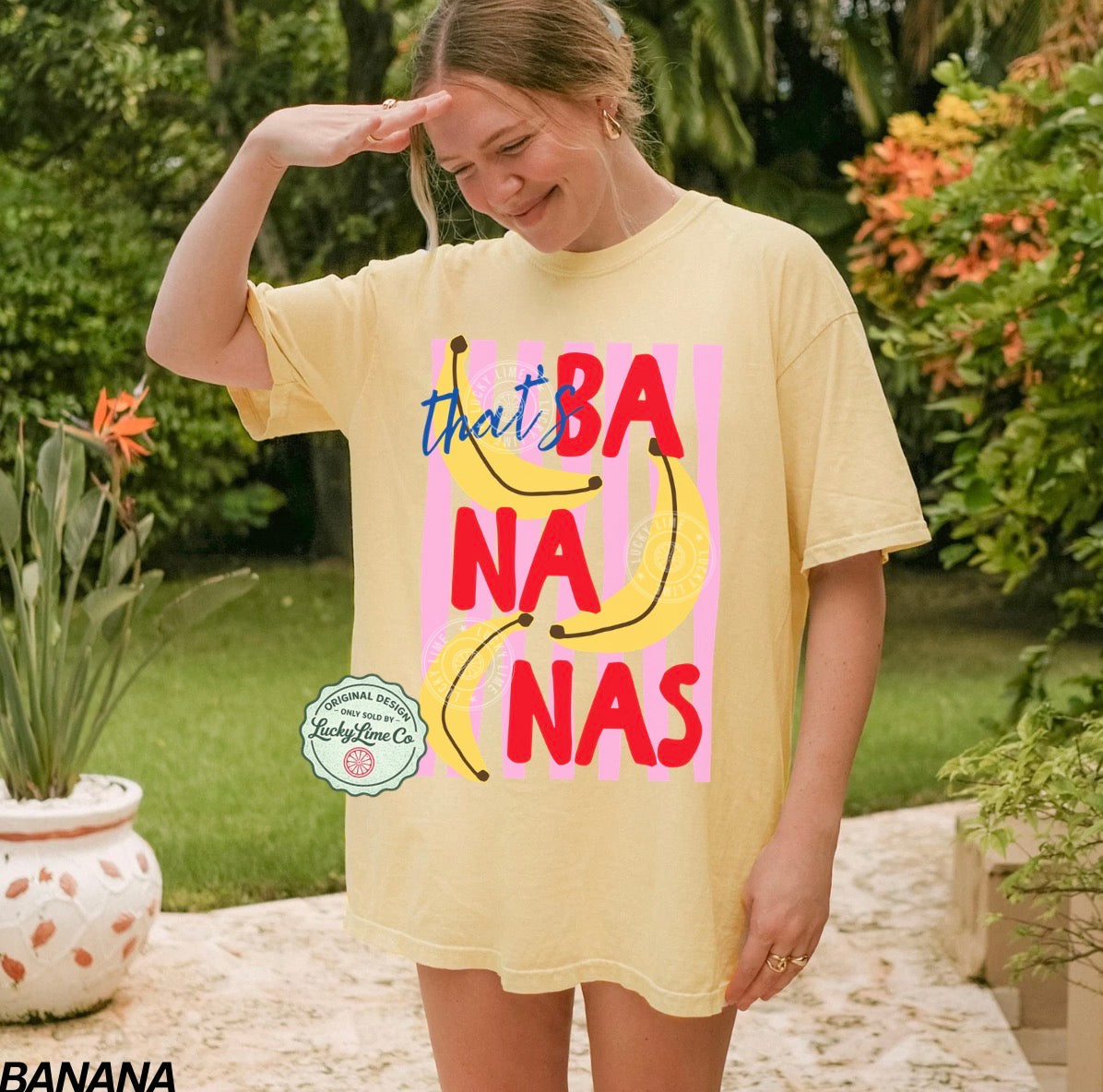 Person wearing a yellow t-shirt with 'that's bananas' text in an outdoor setting