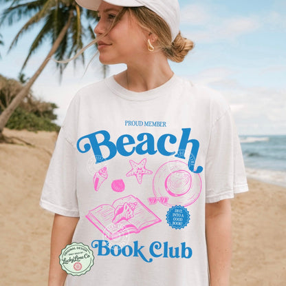 Person wearing a 'Beach Book Club' t-shirt on a beach