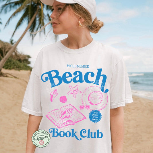 Person wearing a 'Beach Book Club' t-shirt on a beach
