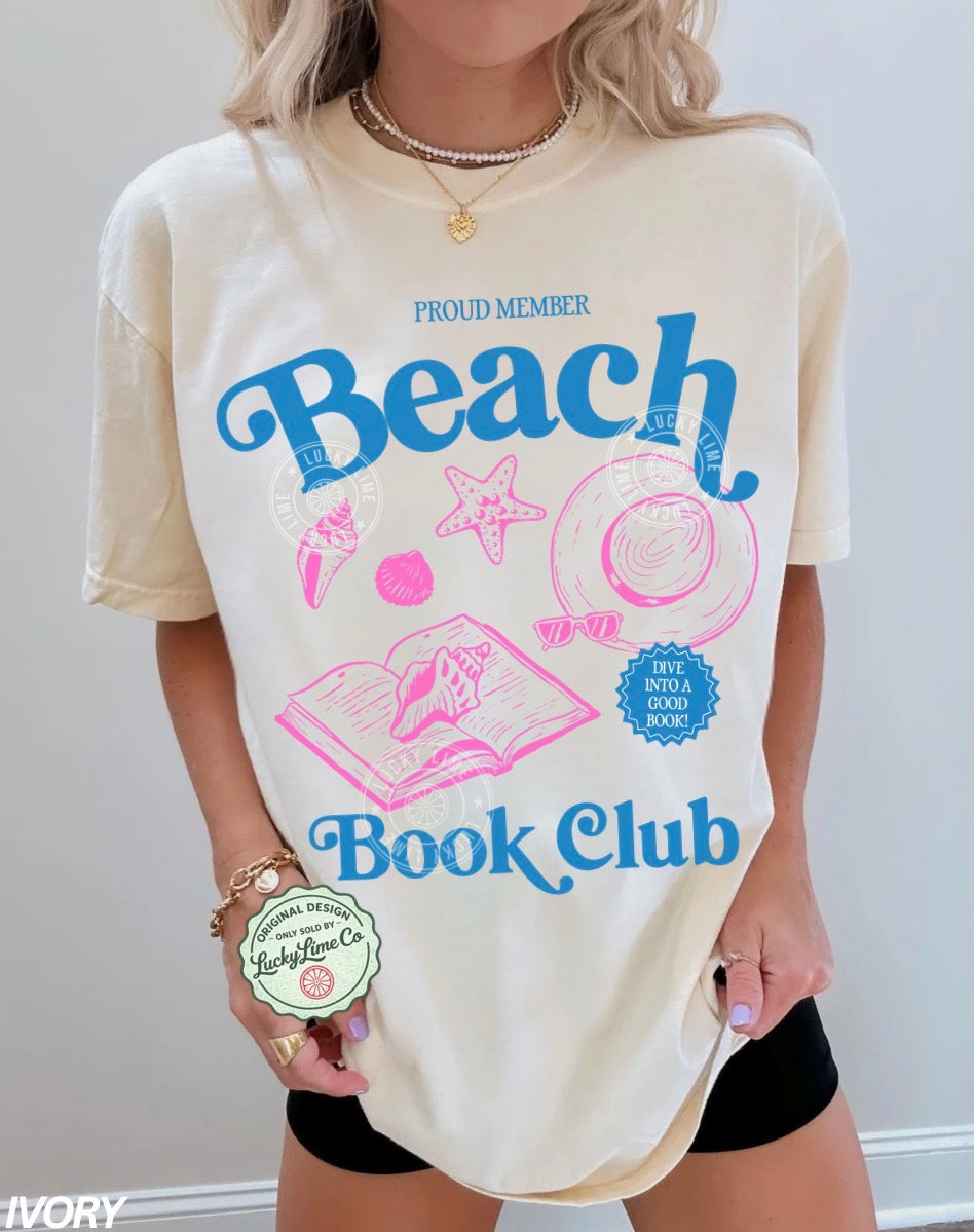 Person wearing a 'Beach Book Club' t-shirt holding a product.