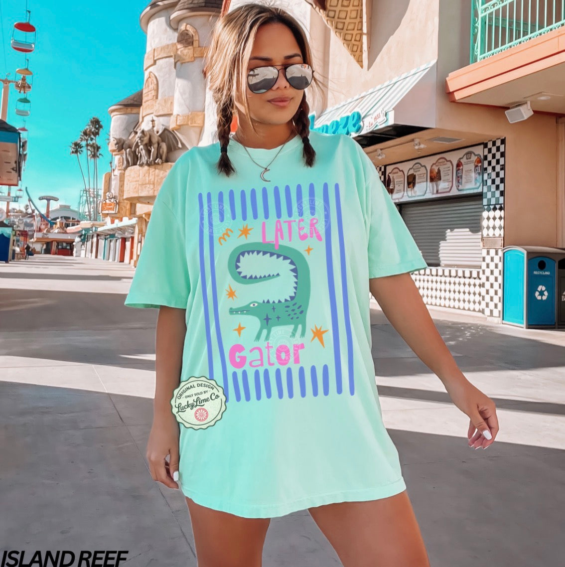 Woman wearing an island reef t-shirt with an alligator graphic and text saying “later gator”