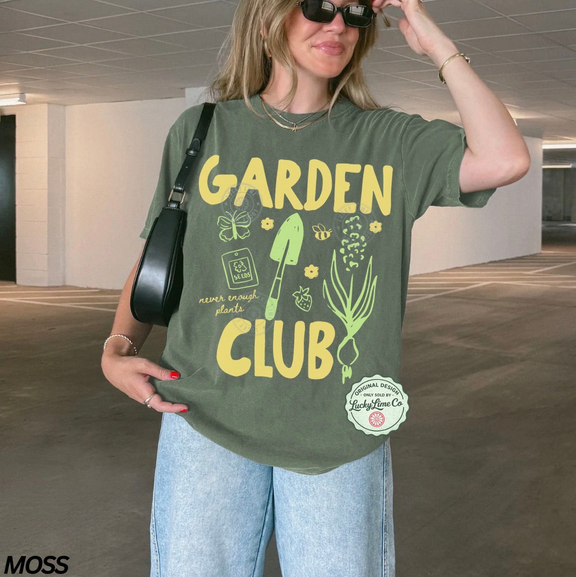 Person wearing a green 'Garden Club' t-shirt in an indoor setting