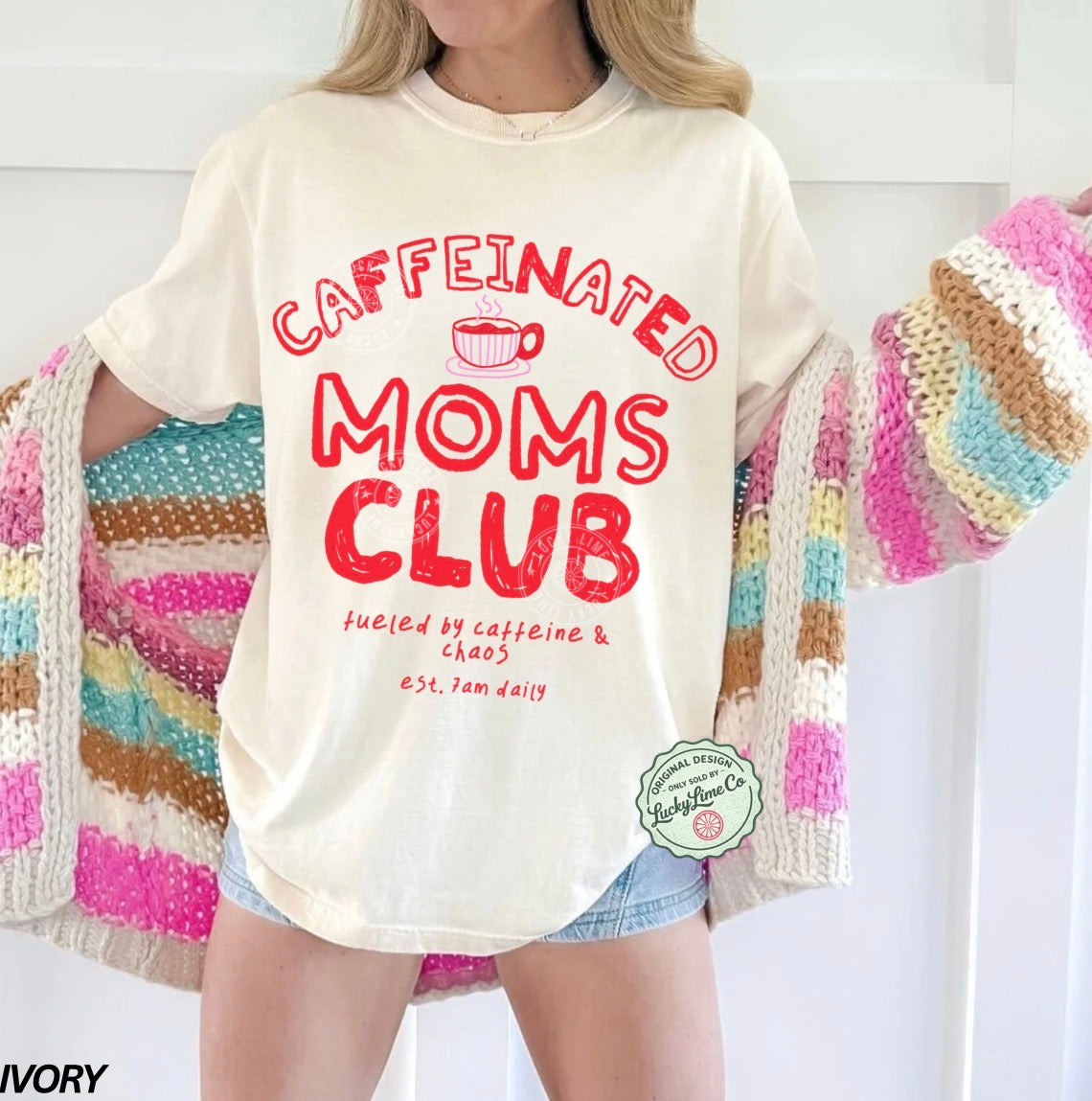 Person wearing a 'Caffeinated Moms Club' t-shirt with a colorful cardigan.