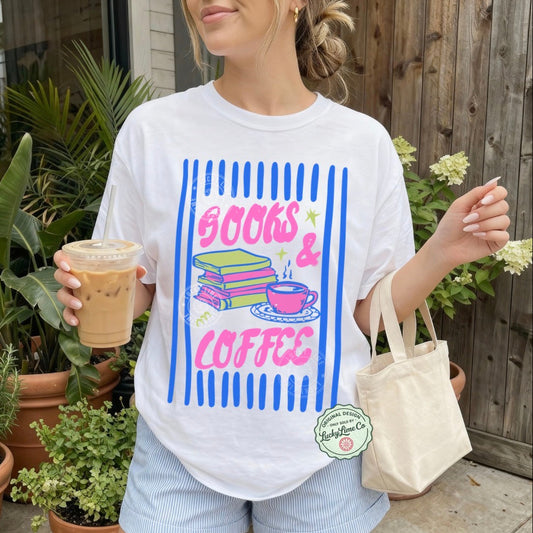 Person wearing a 'Books & Coffee' t-shirt holding iced coffee outdoors.