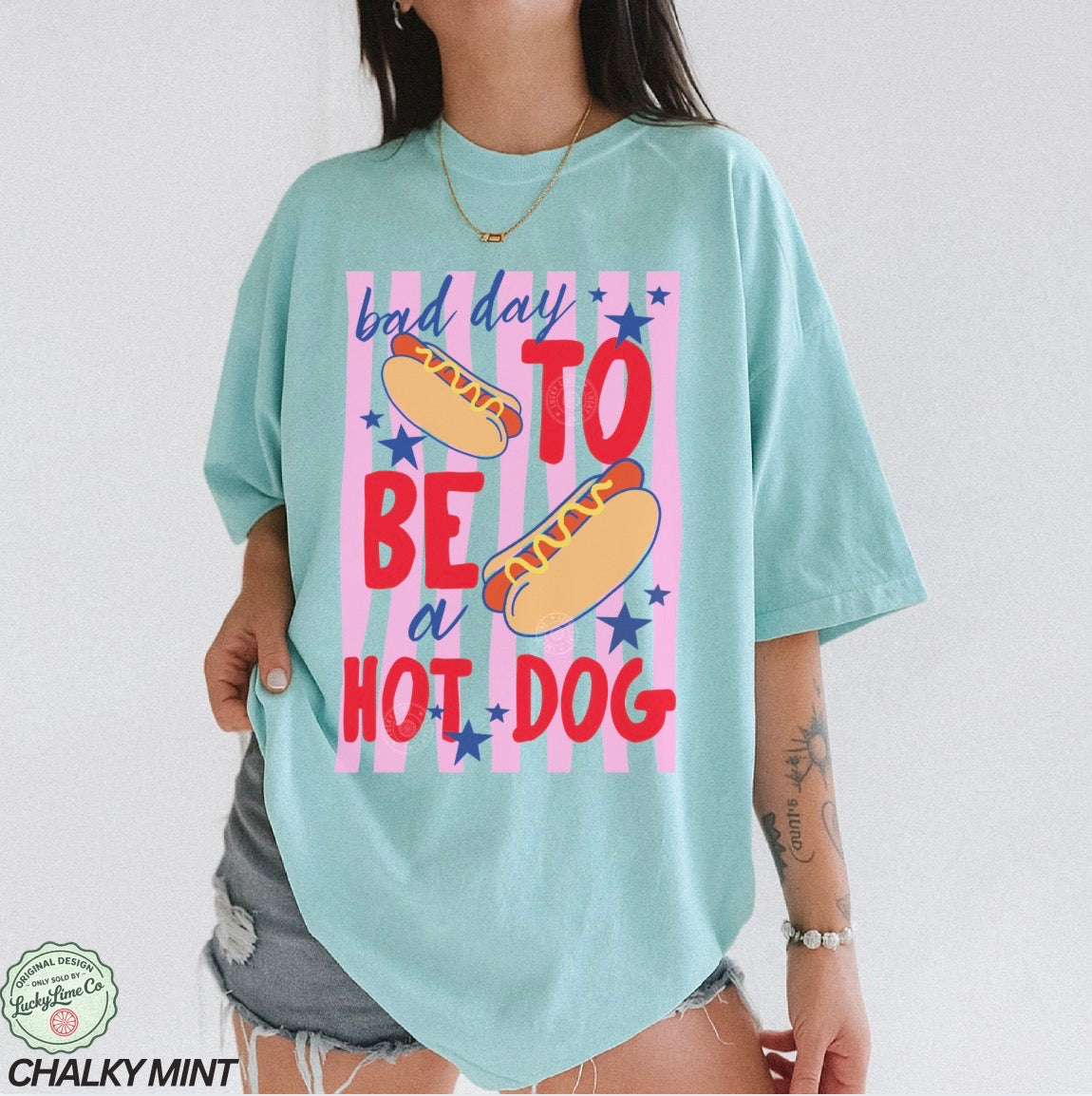 Light blue t-shirt with a colorful graphic and text on a white background