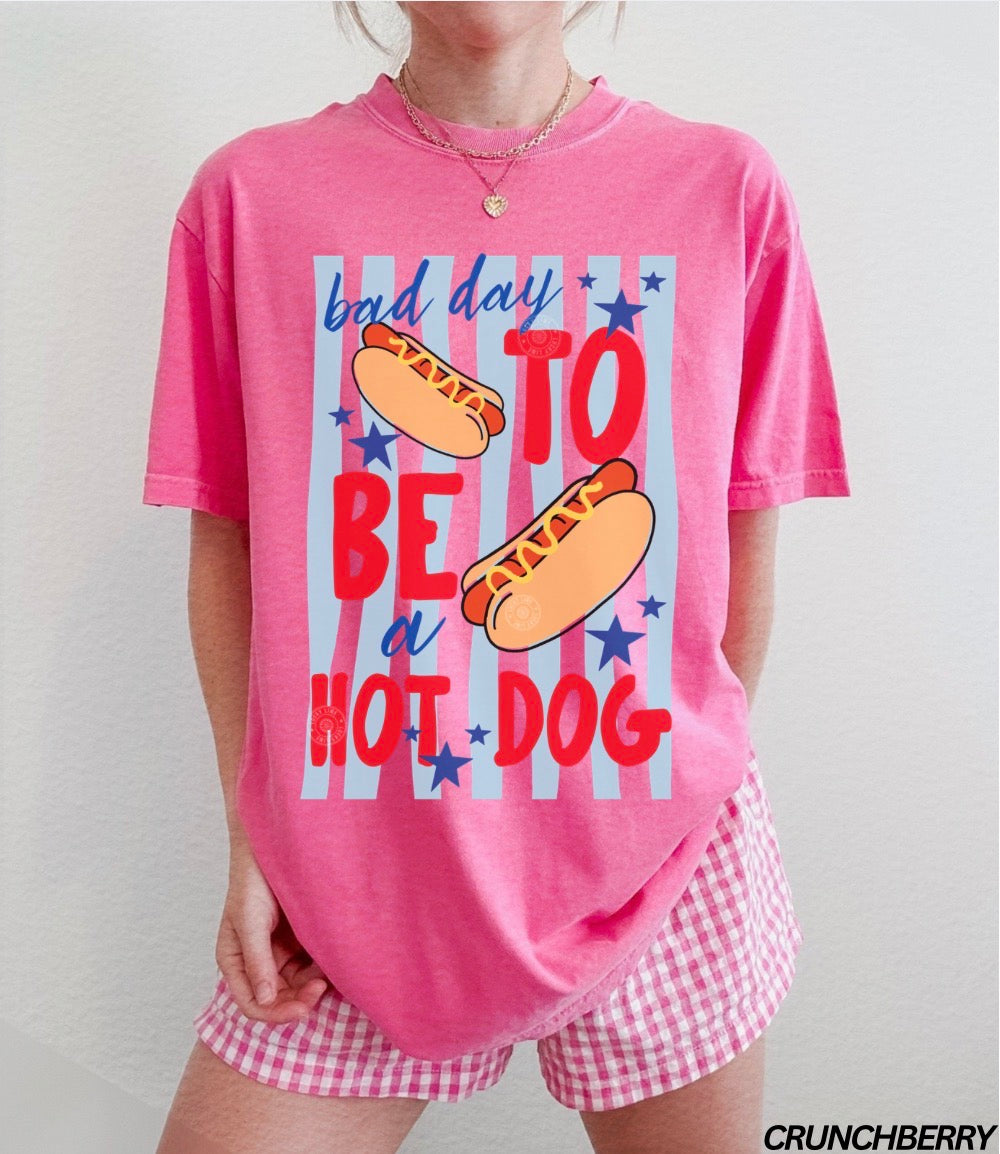 Person wearing a pink pajama set with hot dog graphic and text.