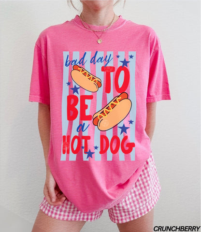 Person wearing a pink pajama set with hot dog graphic and text.