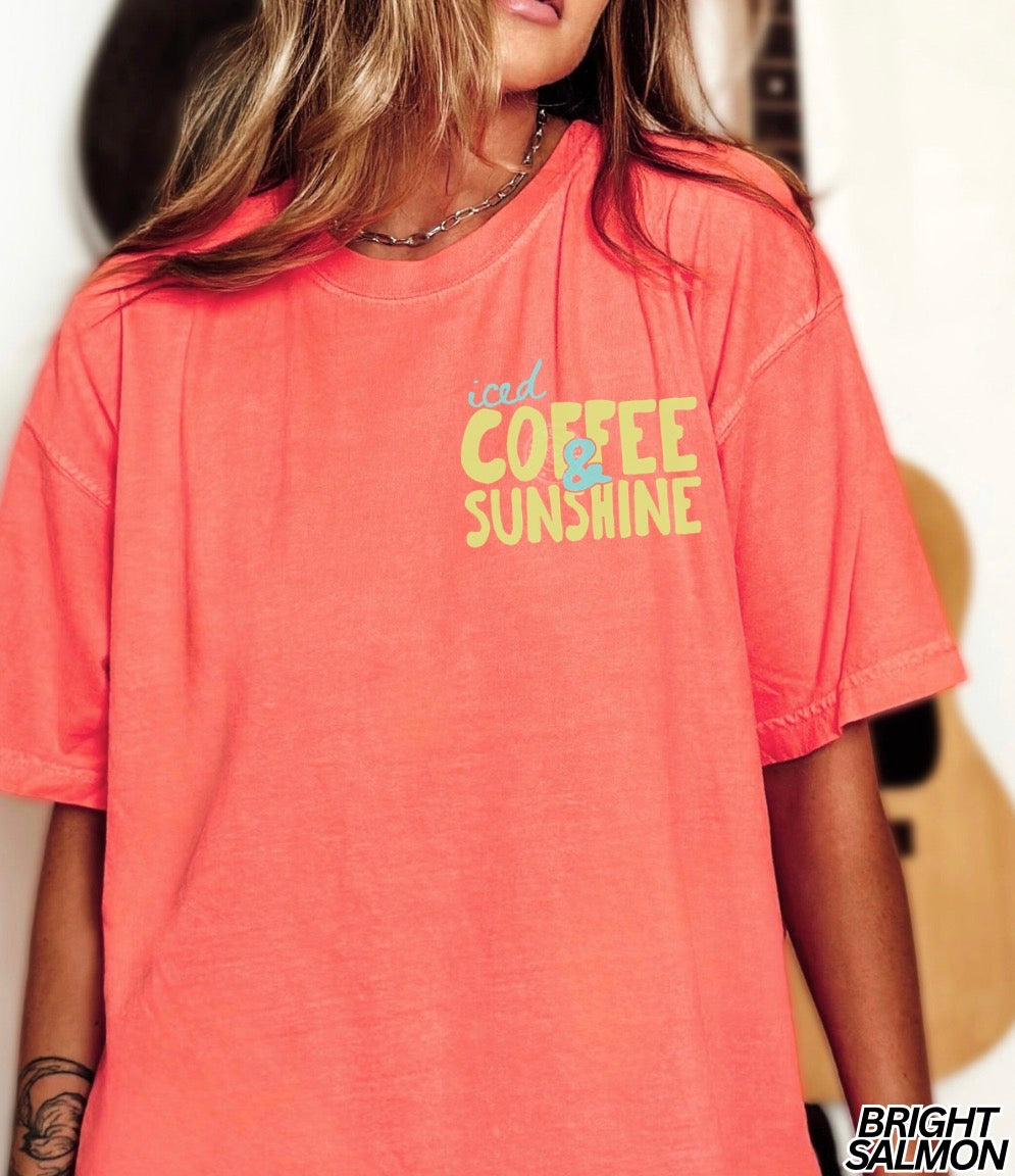 Person wearing a coral t-shirt with 'iced Coffee & Sunshine' text.