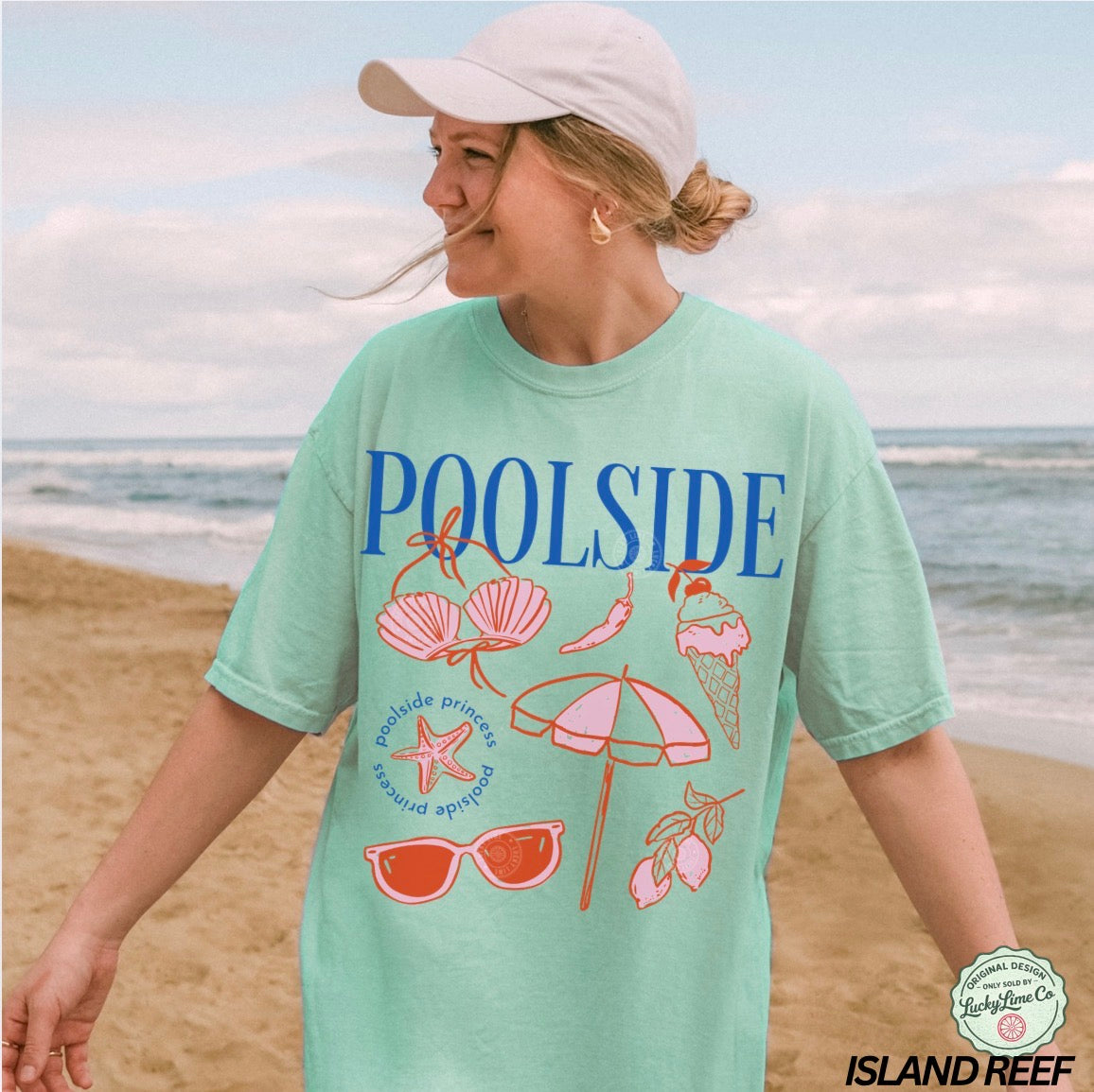 Woman wearing a 'Poolside' t-shirt with beach-themed graphics on a beach.
