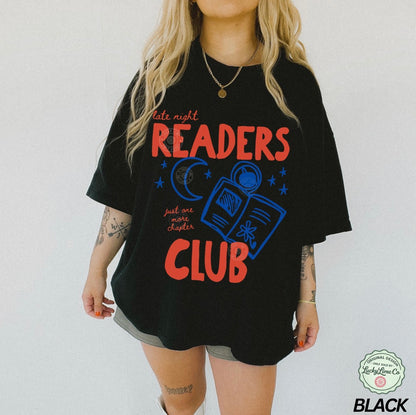 Person wearing a black t-shirt with 'Late night readers club' text and graphics on a white background