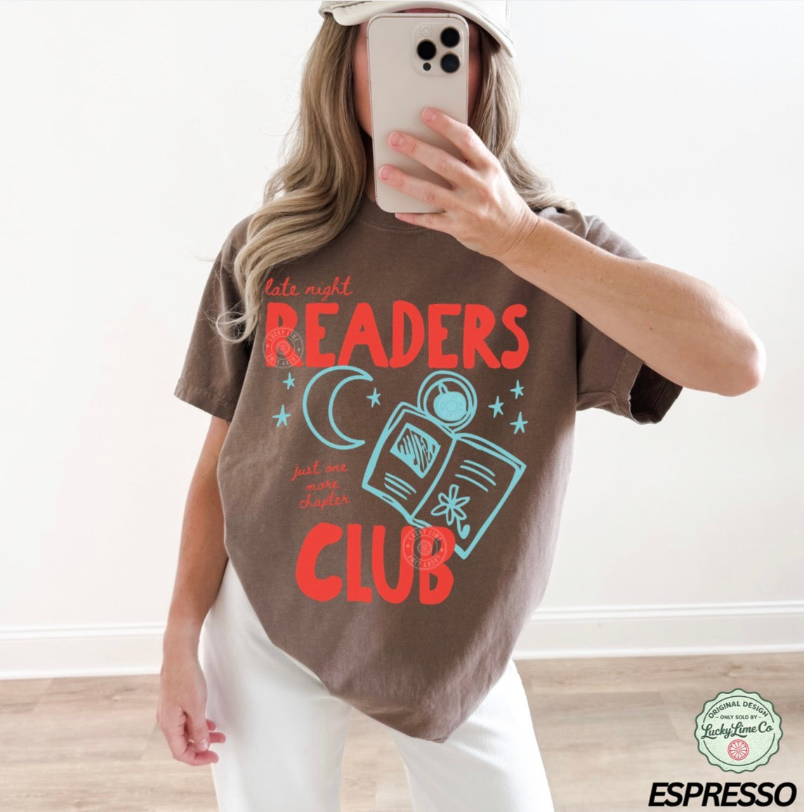 Person wearing a brown t-shirt with 'Late night READERS CLUB' text and graphics.