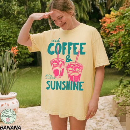 Girl wearing a banana colored shirt with “iced coffee and sunshine’ graphic