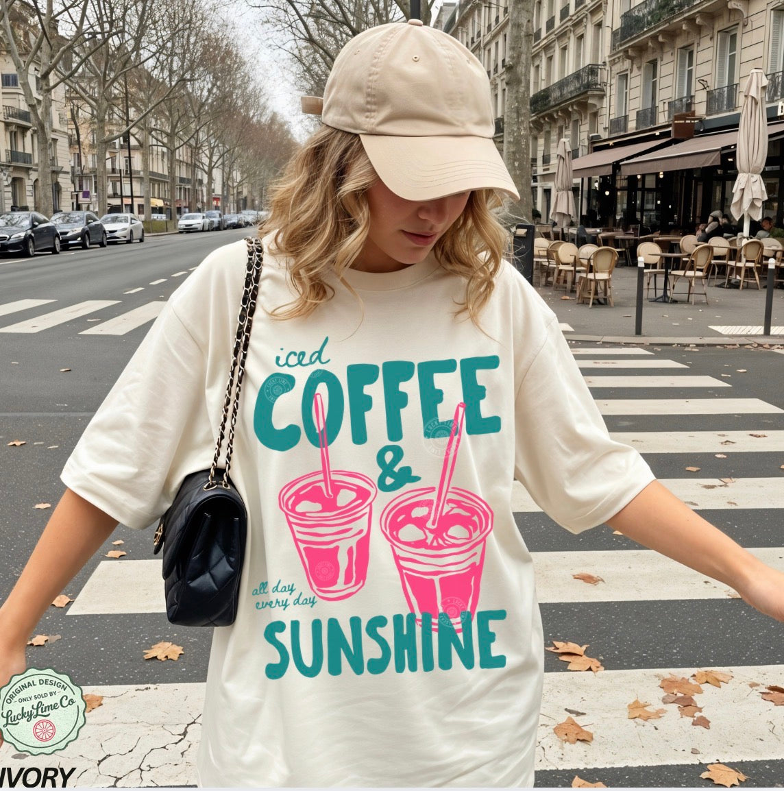 Girl wearing an ivory  shirt with “iced coffee and sunshine’ graphic