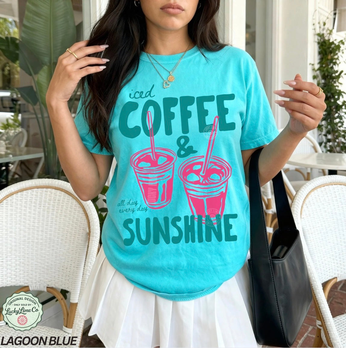Girl wearing a lagoon blue shirt with “iced coffee and sunshine’ graphic