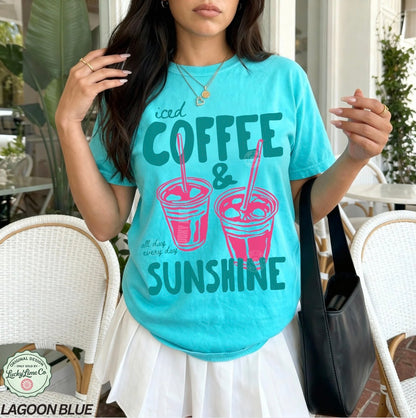 Girl wearing a lagoon blue shirt with “iced coffee and sunshine’ graphic