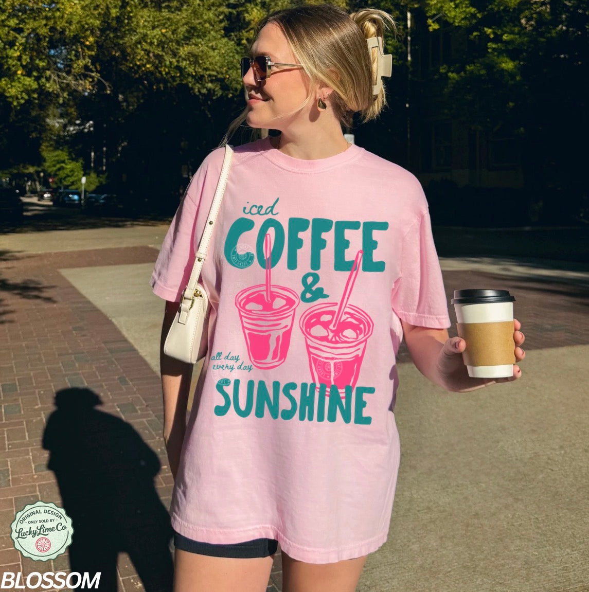 Girl wearing a light pink shirt with “iced coffee and sunshine’ graphic