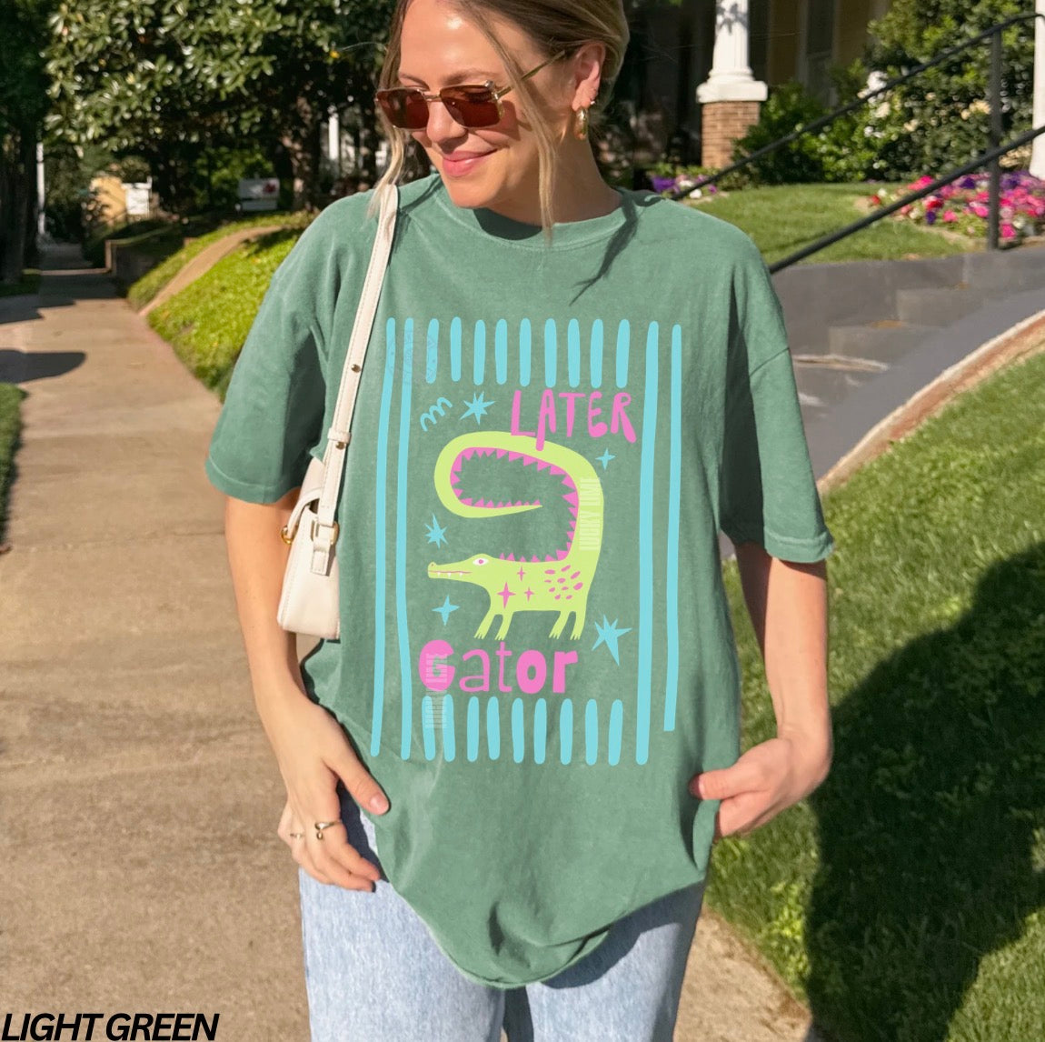 Girl wearing light green colored shirt with “later gator” and alligator graphic