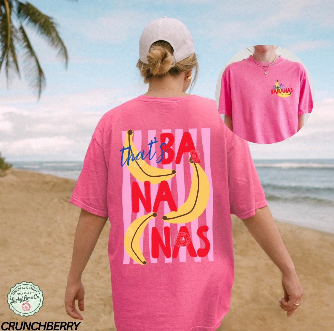 Person wearing a pink t-shirt with banana graphics and text on a beach.