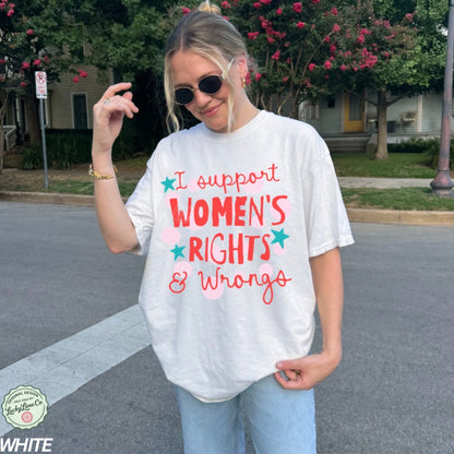 Person wearing a white t-shirt with 'I support WOMEN'S RIGHTS & Wrongs' text outdoors.