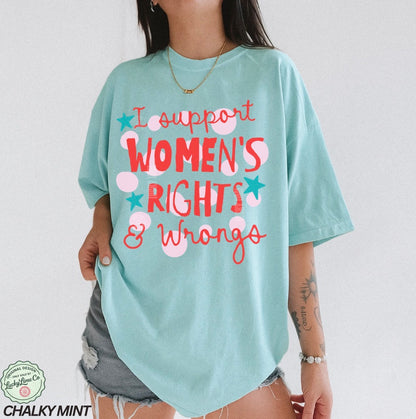 Person wearing a light blue t-shirt with text 'I support WOMEN'S RIGHTS & Wrongs' on a plain background