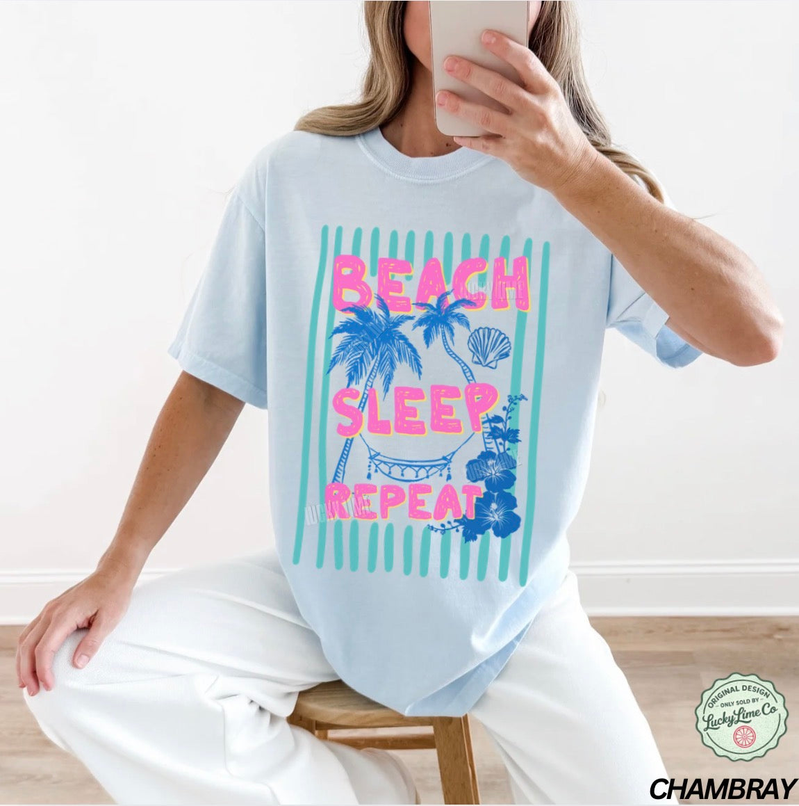 Person wearing a light blue t-shirt with 'Beach Sleep Repeat' text and graphics.