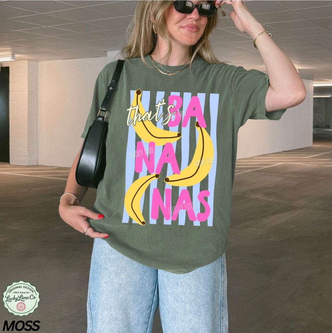 Person wearing a green t-shirt with banana graphic and text in an indoor setting