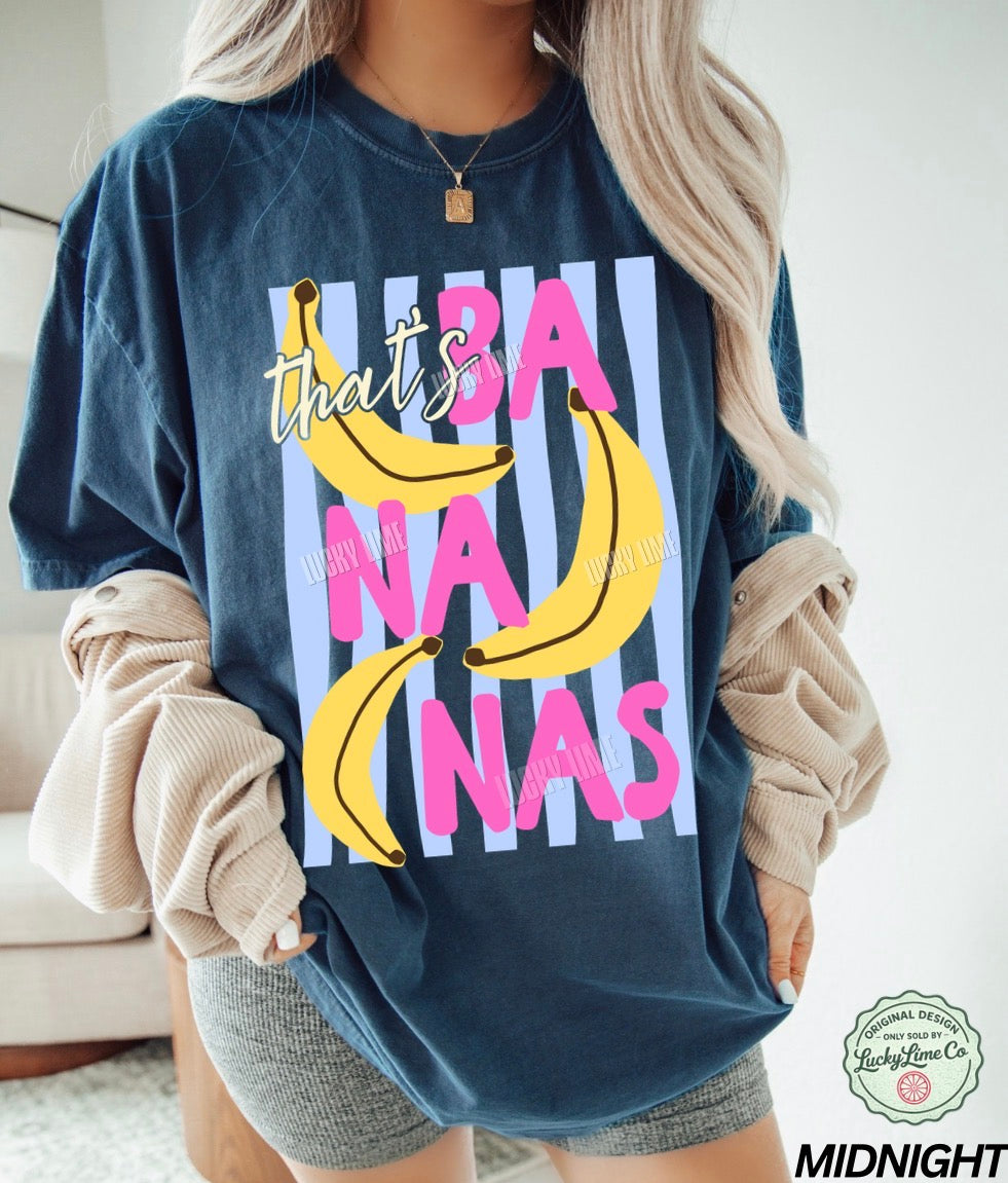 Person wearing a navy blue sweatshirt with colorful banana graphic and text.