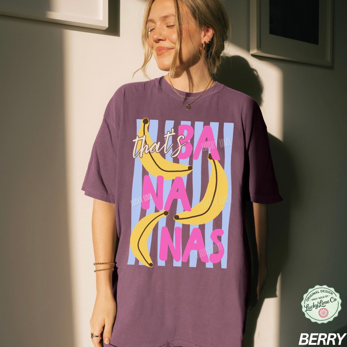 Person wearing a purple t-shirt with banana graphic and text