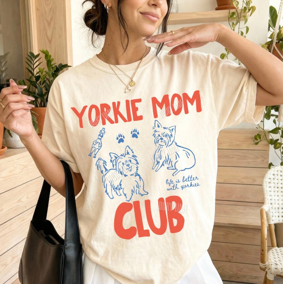 Woman wearing a 'Yorkie Mom Club' t-shirt outdoors