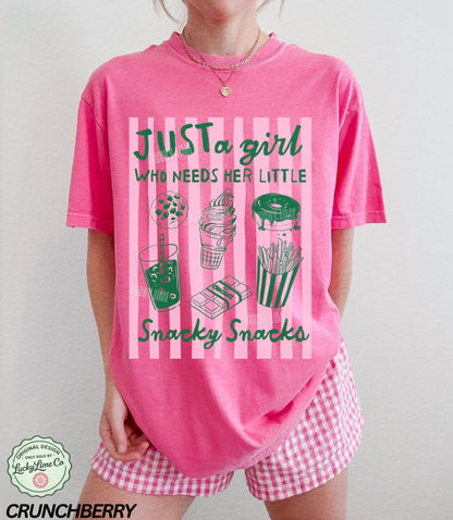 Person wearing a pink t-shirt with snack-themed design and matching shorts.