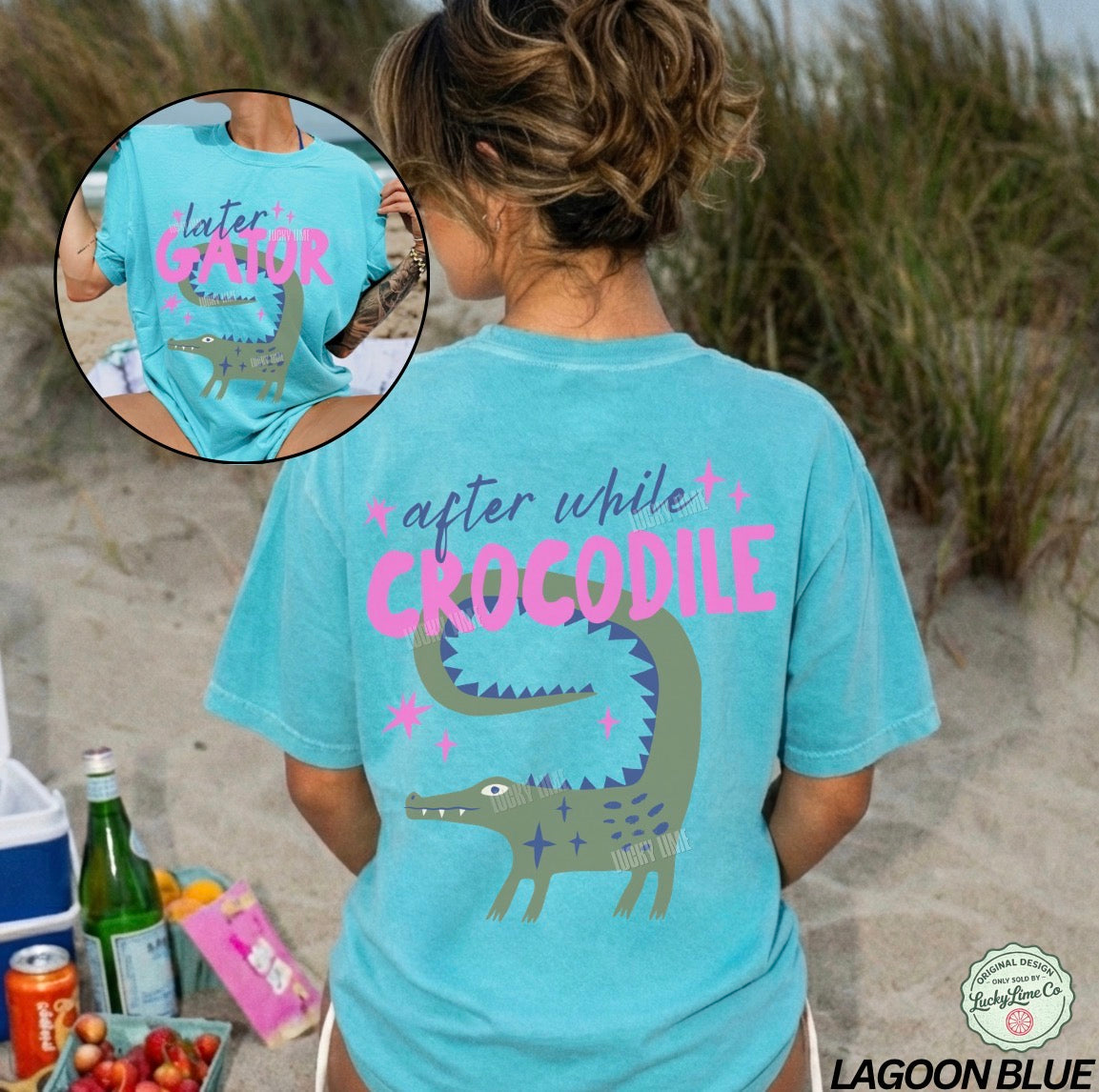 Person wearing a turquoise t-shirt with a crocodile graphic and text on a beach.